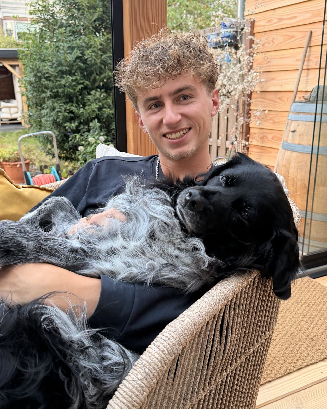 Pepijn with two dogs on his lap